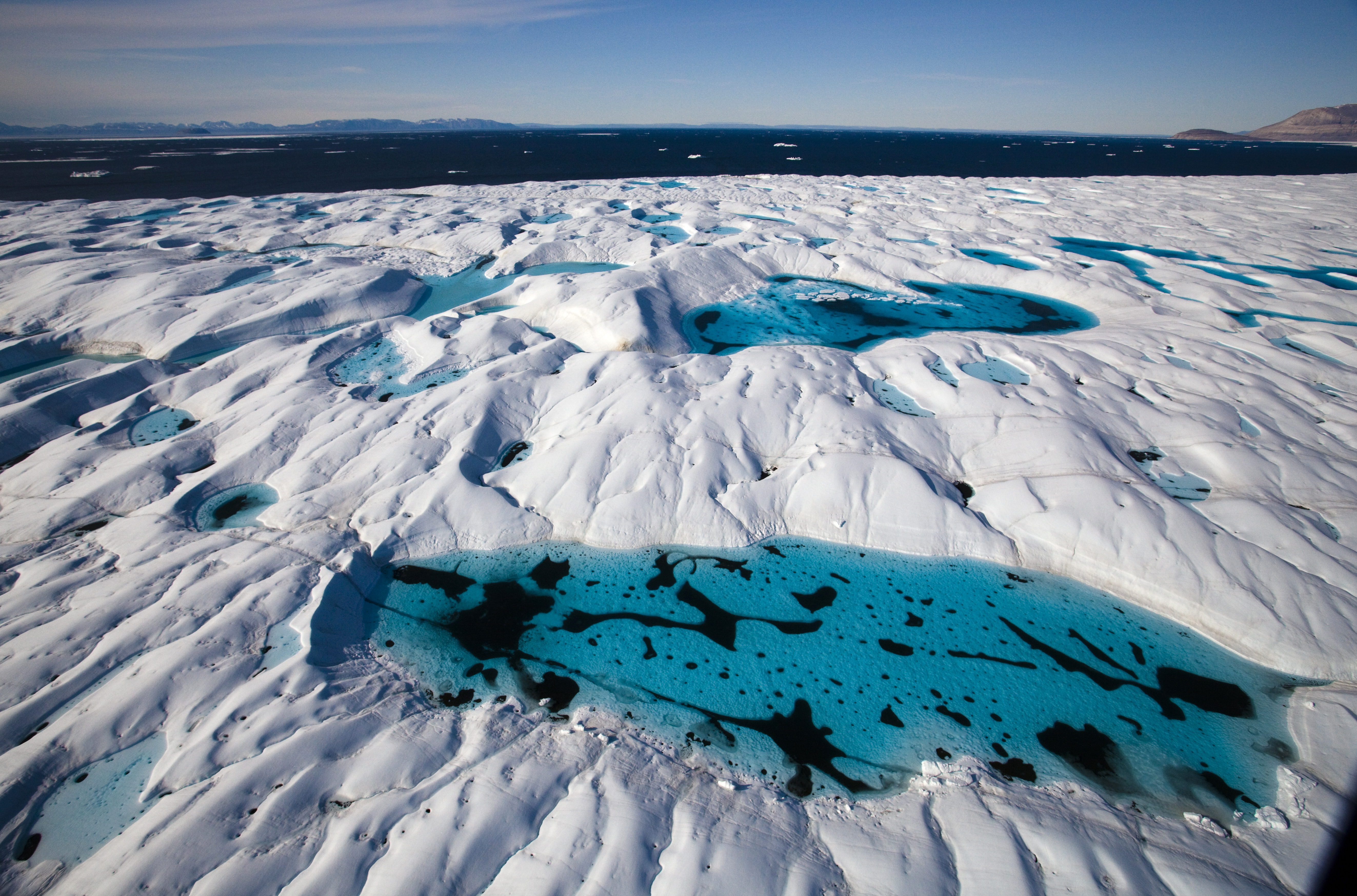 Aerial views of melt pools and melt rivers on Petermann Glacier